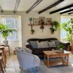 country cottage vibes with white wooden blinds in the windows